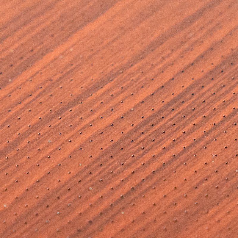 Close-up of micro-perforated aluminum panel, tiny round hole CNC punching detail, acoustic perforated metal panel for interior ceiling noise reduction