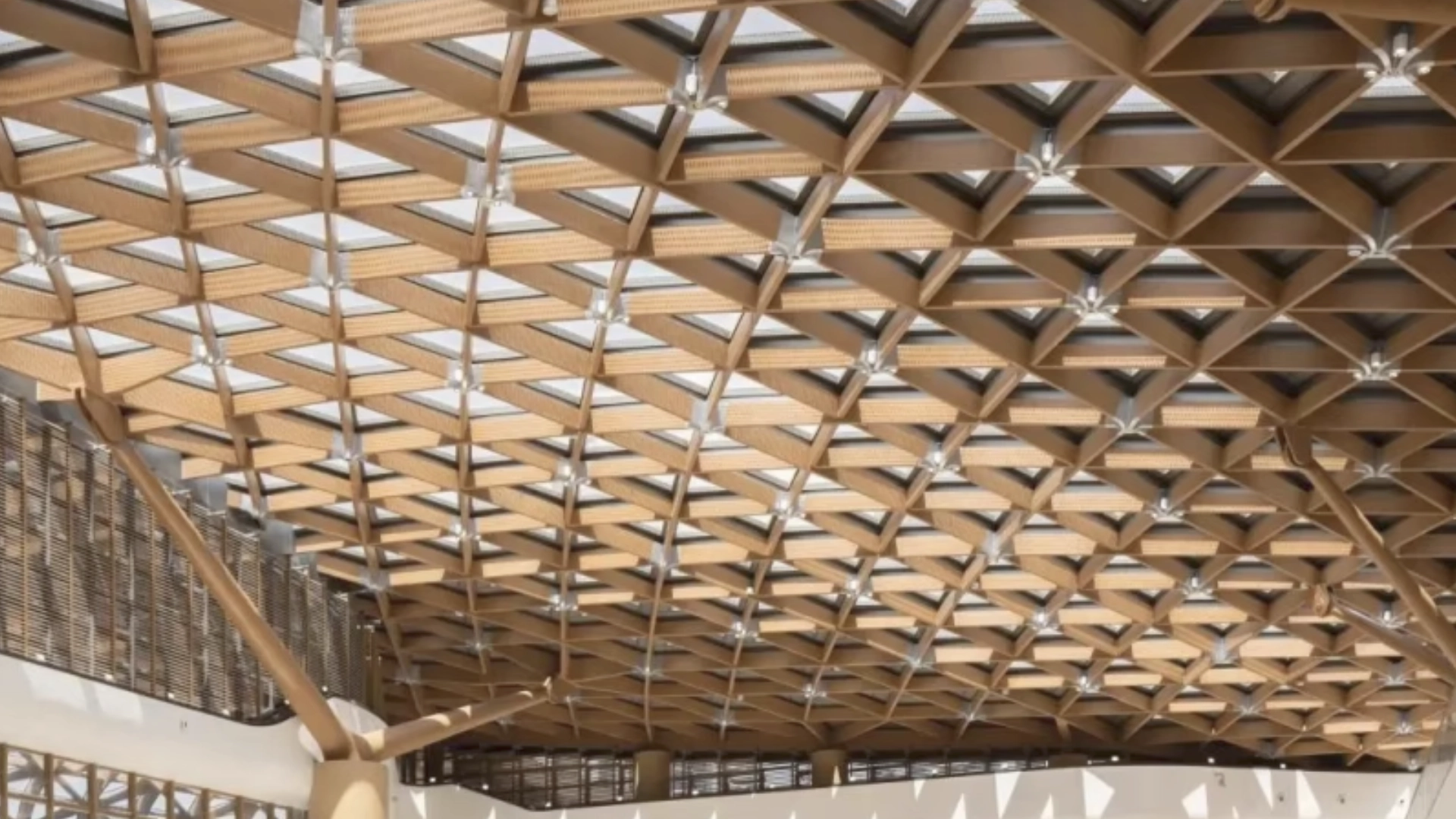 Real project application of Lindelacr champagne gold woven metal wire mesh suspended ceiling in commercial lobby interior