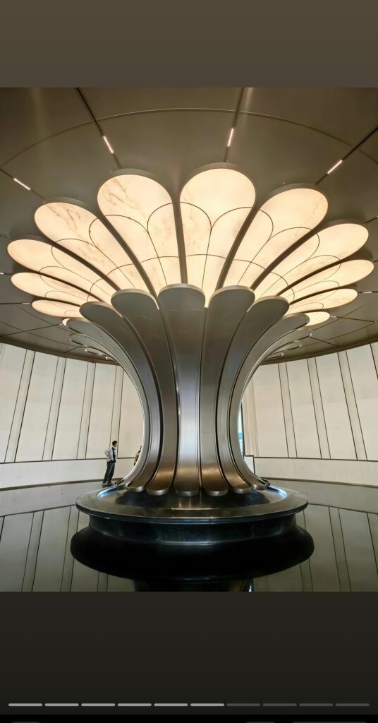 CTS Baichen Yunqi lobby centerpiece with backlit petal canopy and dark metal column cladding by LINDELACR