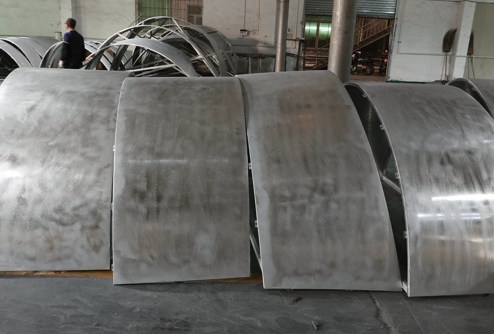 LINDELACR Foshan plant: CNC-formed curved aluminum facade panels standing after brake forming, ready for PVDF and crate