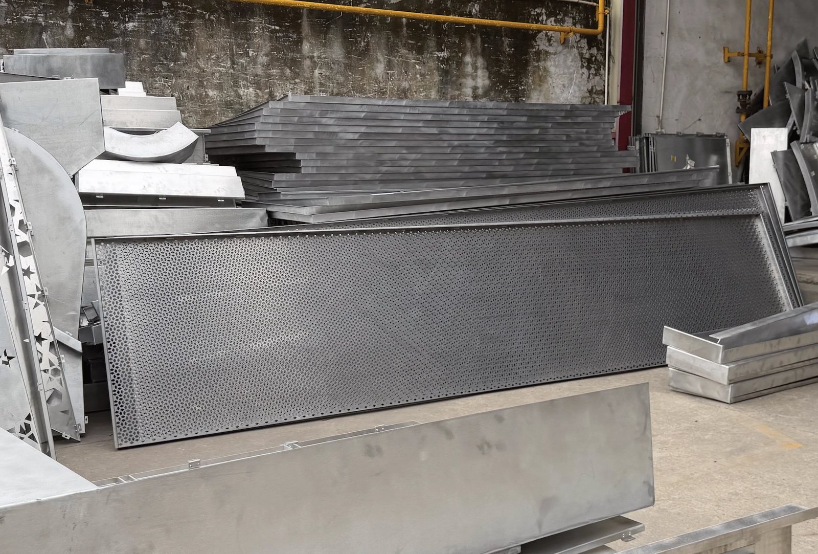 Factory-formed perforated aluminum cassette with folded returns before PVDF coating, Foshan shop floor