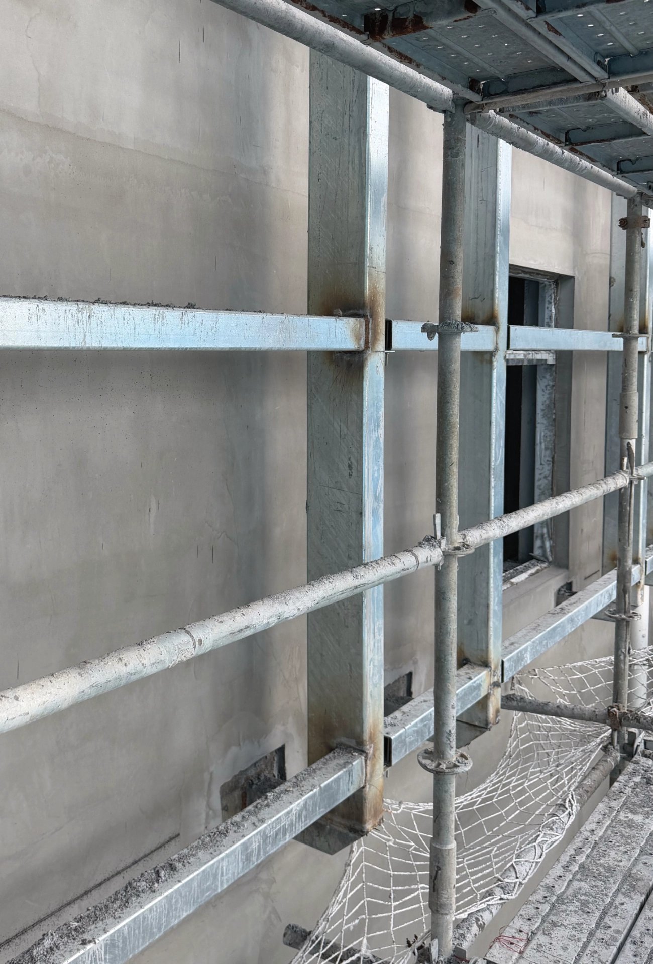 Welded galvanized steel subframe on the concrete wall of Zhaoqing Southern Power Grid before aluminum cassettes