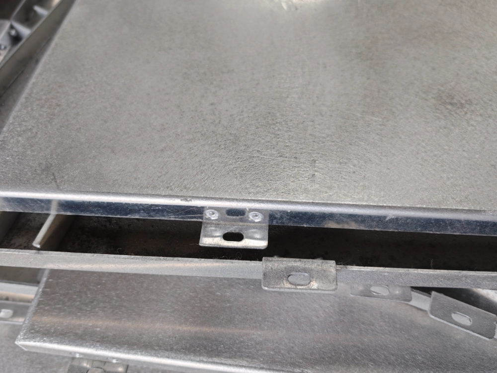 Mill-finish aluminum ceiling cassette with corner brackets and folded returns that set install thickness