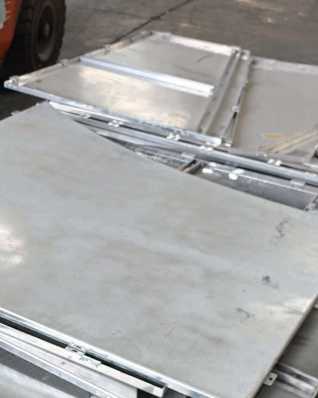 Folded aluminum wall cassettes stacked after the brake, returns and hanging brackets visible