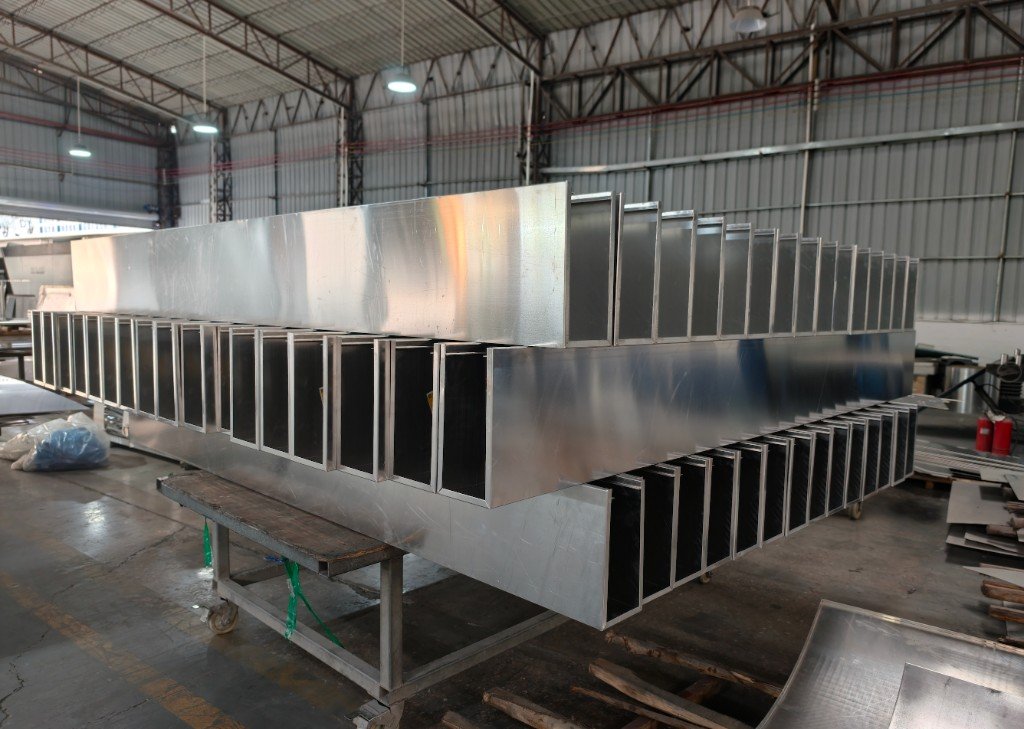 LINDELACR mill-finish aluminum cassettes with folded returns stacked on a shop trolley after the brake