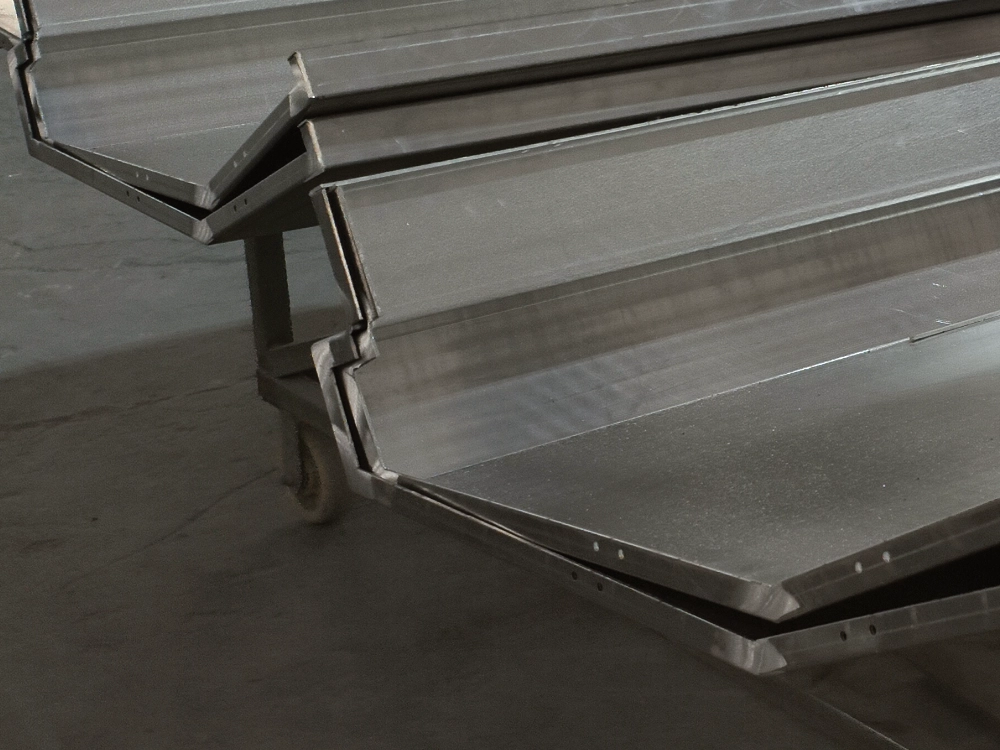LINDELACR shop-folded mill-finish aluminum cassette on a trolley: return and face before wood-grain or powder