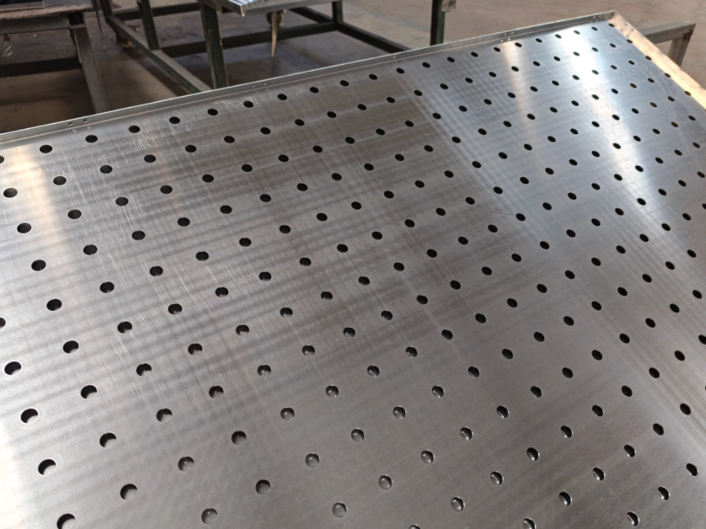 LINDELACR mill-finish perforated aluminum sheet in the Foshan shop: regular hole field and a folded long-edge return