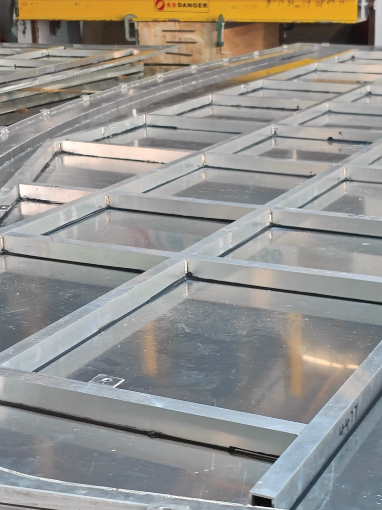 LINDELACR shop-welded aluminum cassette frames on the floor, grid bars and sheet infill before coating