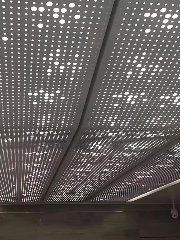 LINDELACR variable-diameter perforated aluminum ceiling with backlight through the hole field