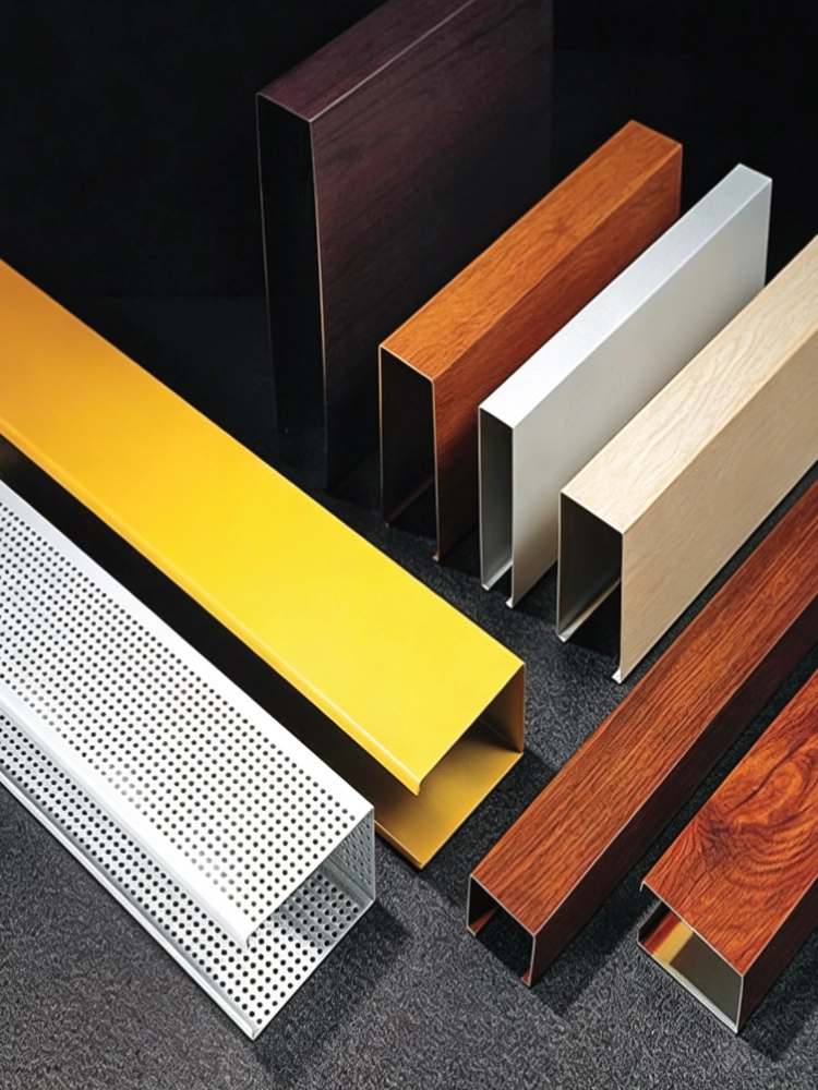 LINDELACR aluminum U-baffle samples: wood-grain transfer in several tones, powder yellow, white, and a white perforated tube