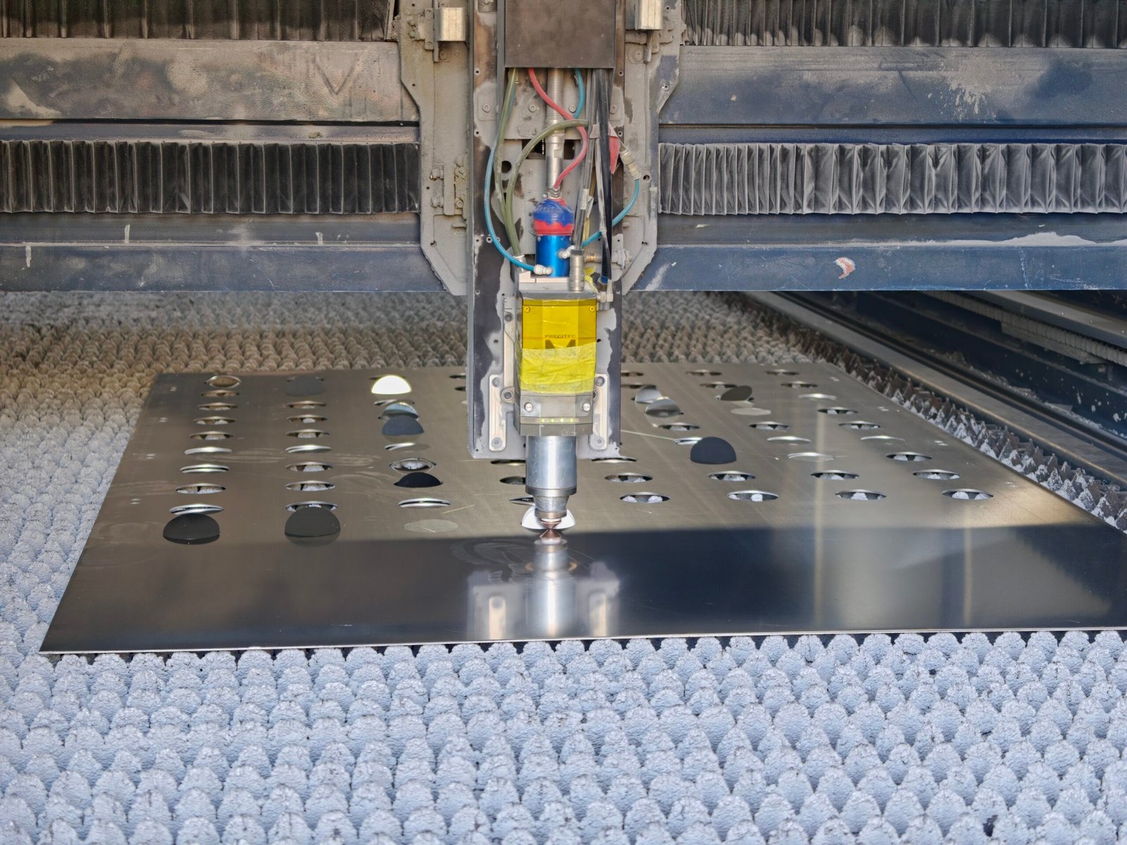 Cutting head working openings into a mill-finish aluminum sheet in the Foshan shop