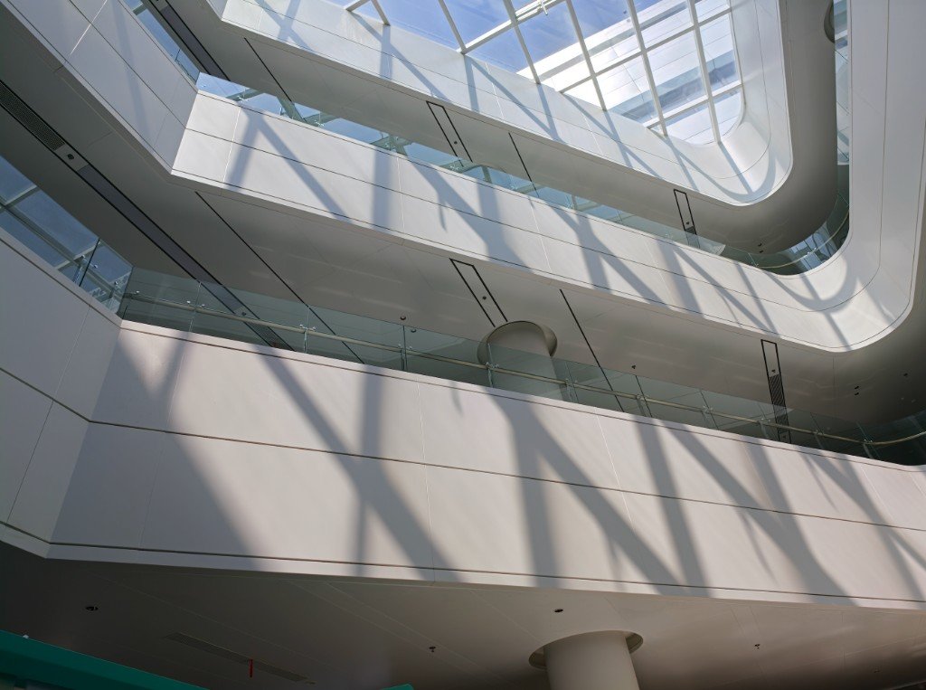Large white soffit panels under a skylight, with the joint running the length of each panel