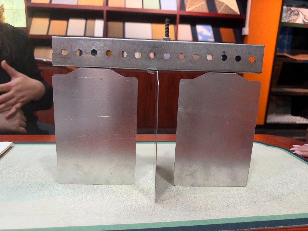 Two mill-finish aluminum blades on a punched carrier, with a threaded hanger between them